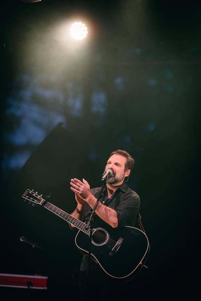 Mac Powell sings into a microphone