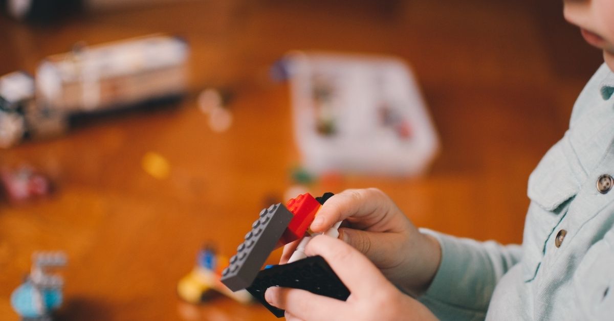 young boy playing with lego