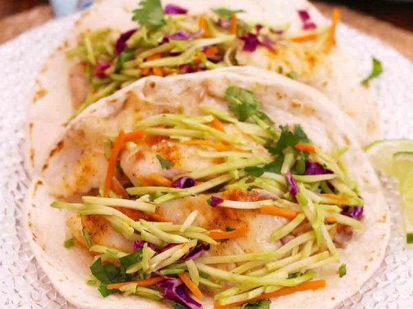 photo shows a fish taco with broccoli slaw