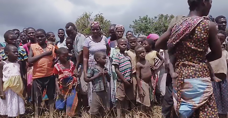 esidents of an isolated community in Beira, Mozambique gather and wait as aid is delivered by World Vision.
